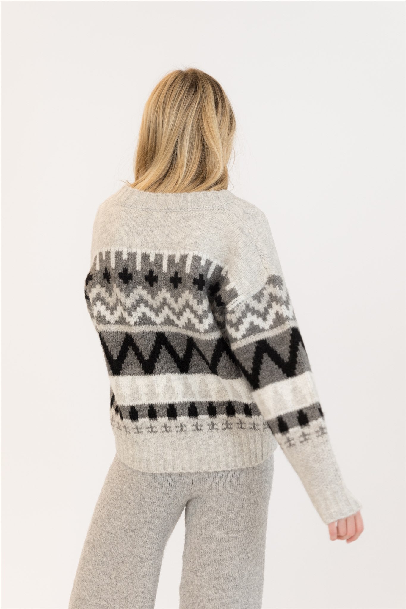 Pearls Boutique| Port Dover Ontario|Lyla + Lux |  Landen Grey Mix Crewneck. Lyla + Lux women’s crewneck pullover sweater featuring a grey and black colour block Aztec design. Classic crew neckline, dropped shoulders, and a relaxed fit for an effortlessly casual silhouette. Crafted from a soft knit blend of acrylic, polyester, and elastane, this sweater offers cozy comfort with a subtle stretch. 