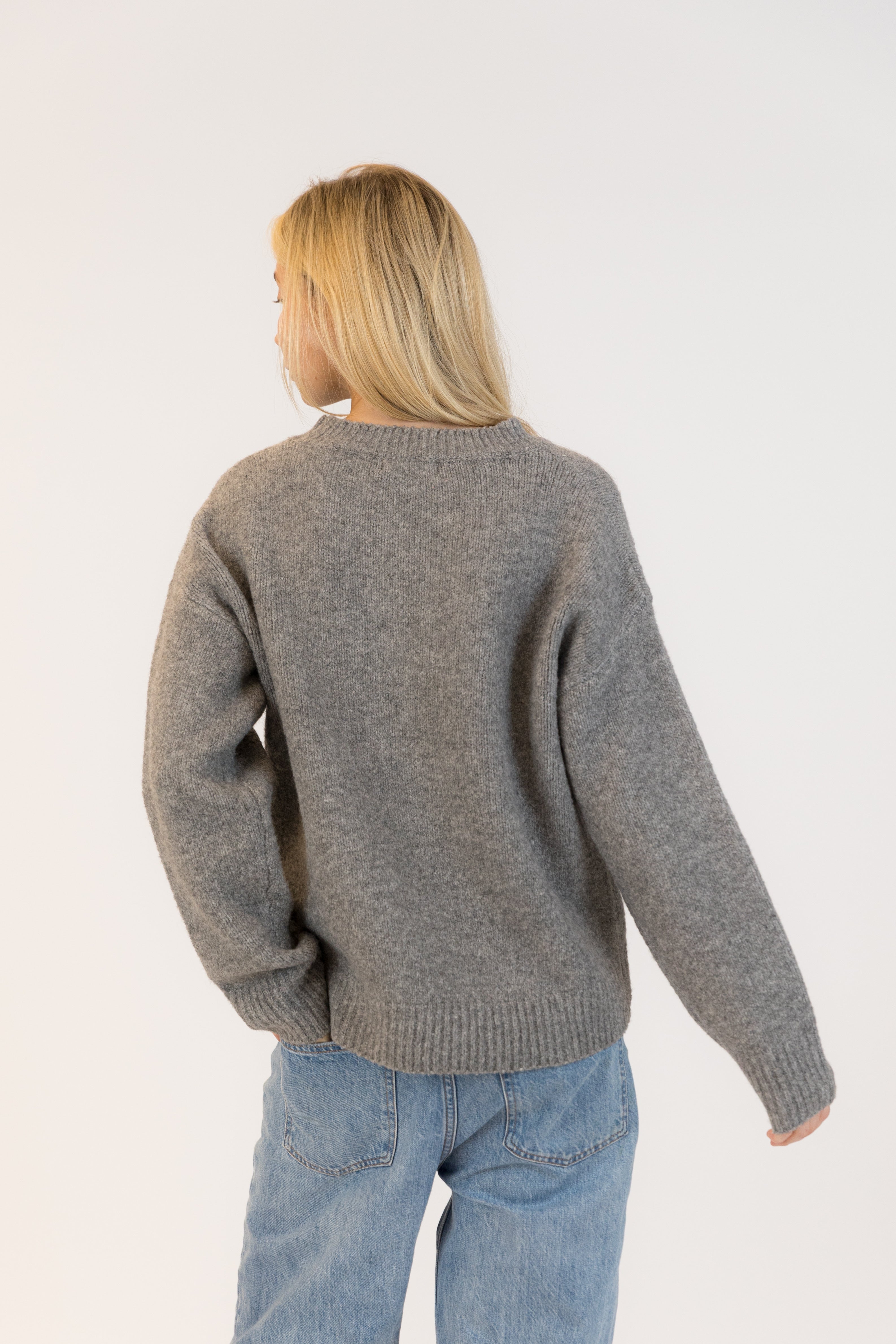 Pearls Boutique| Port Dover Ontario| Lyla + Lux | Lou Crewneck Pullover| women’s crewneck pullover sweater in a charcoal grey knit, featuring playful black cherry embroidery across the front. polyester, acrylic, polyamide, wool, and elastane, this sweater is designed with a classic crew neckline, dropped shoulders, and a relaxed fit for laid-back comfort. The plush, breathable fabric makes it perfect for layering or wearing on its own, adding a subtle yet fun detail to casual fall and winter outfits.
