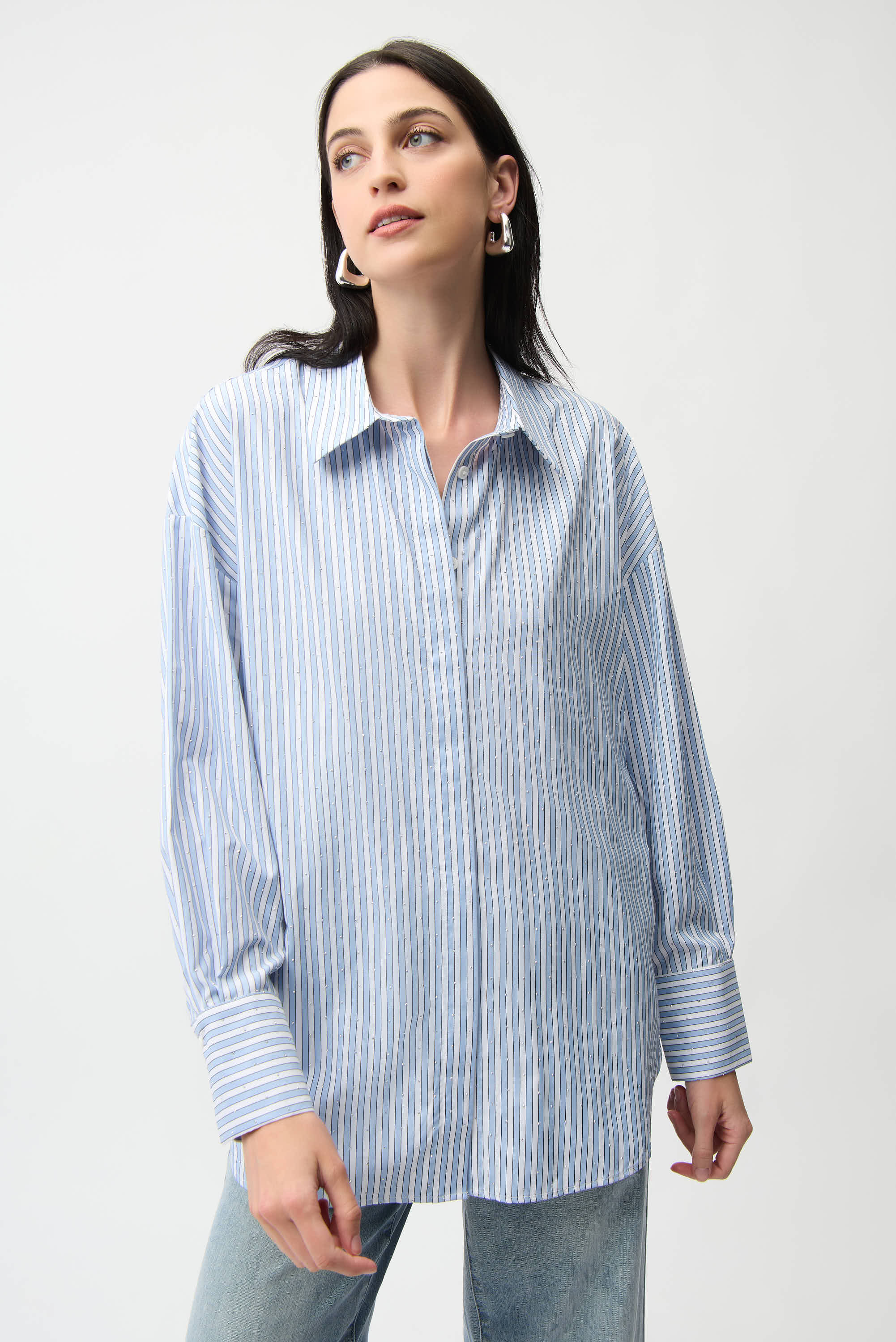 Woman wearing a blue and white striped shirt against a plain background. Pearls Boutique Port Dover, Ontario