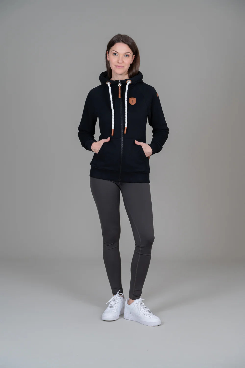 Pearls Boutique - Port Dover Ontario - Wanakome - Hera Black  - Hera Full-Zip Hoodie: our most popular and in-demand. Available in four stylish colors for a versatile wardrobe addition. Boasts a timeless design with a nautical touch. Perfect for adventure enthusiasts or chilly nights by the beach. Seamlessly combines style and comfort. Offers both warmth and fashion-forward appeal. Embrace the perfect blend of fashion and functionality with this essential.Pockets and full zip front
